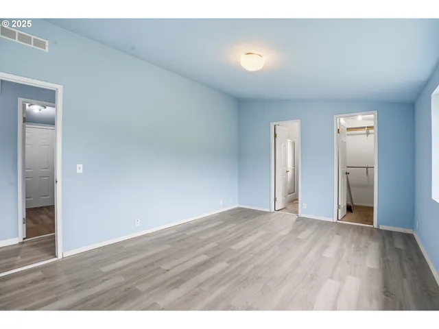 a view of an empty room and wooden floor