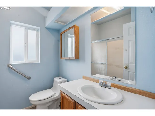 a bathroom with a toilet sink and mirror