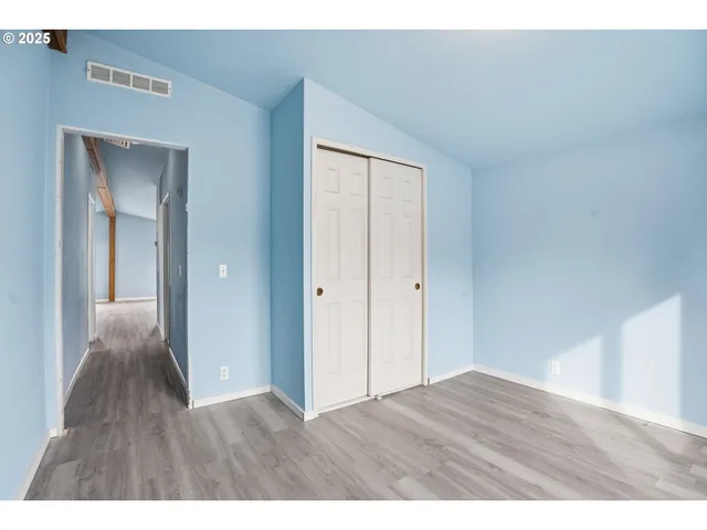 a view of an empty room and wooden floor