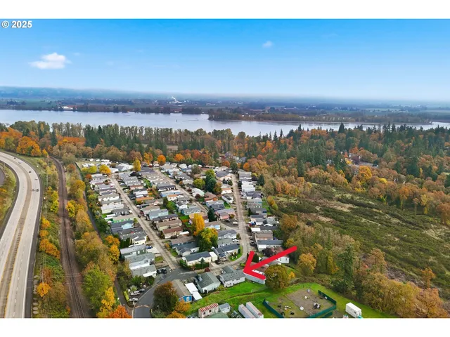 an aerial view of residential houses with city view