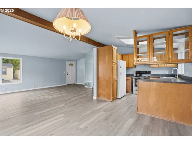 a kitchen view with wooden floor and window