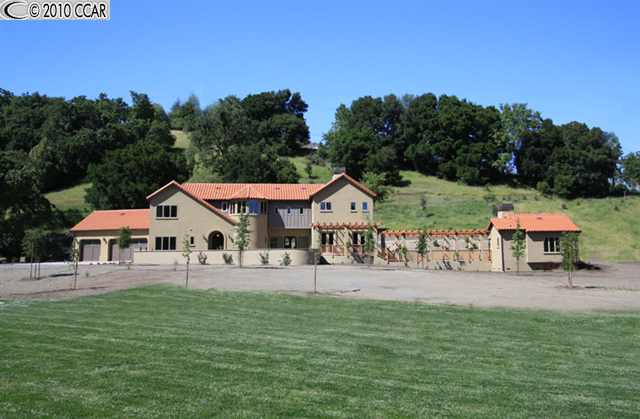 an outdoor space with patio and white umbrellas