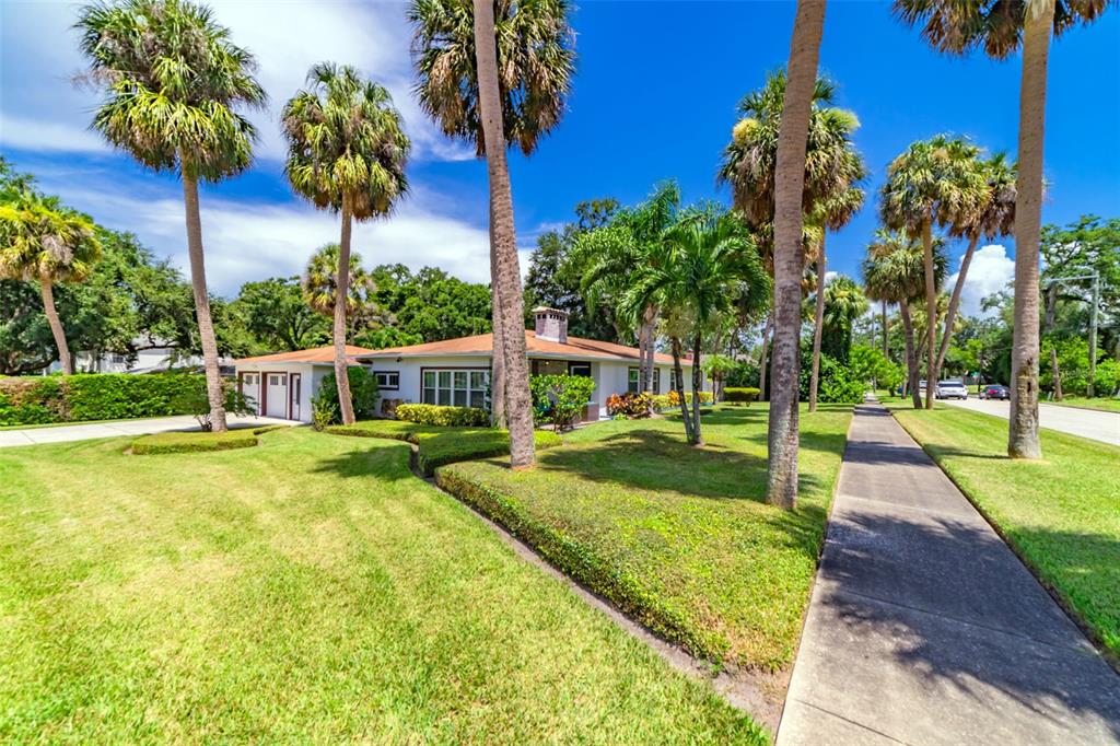 a view of a house with swimming pool and a yard