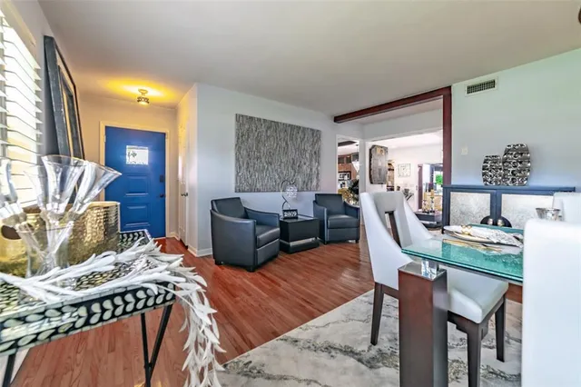 a kitchen with stainless steel appliances granite countertop a sink a stove and a refrigerator