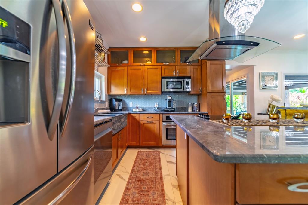 4201 West Dale Avenue Tampa, FL 33609 - Photo 18 of 77 a kitchen with stainless steel appliances granite countertop a sink a stove and a refrigerator