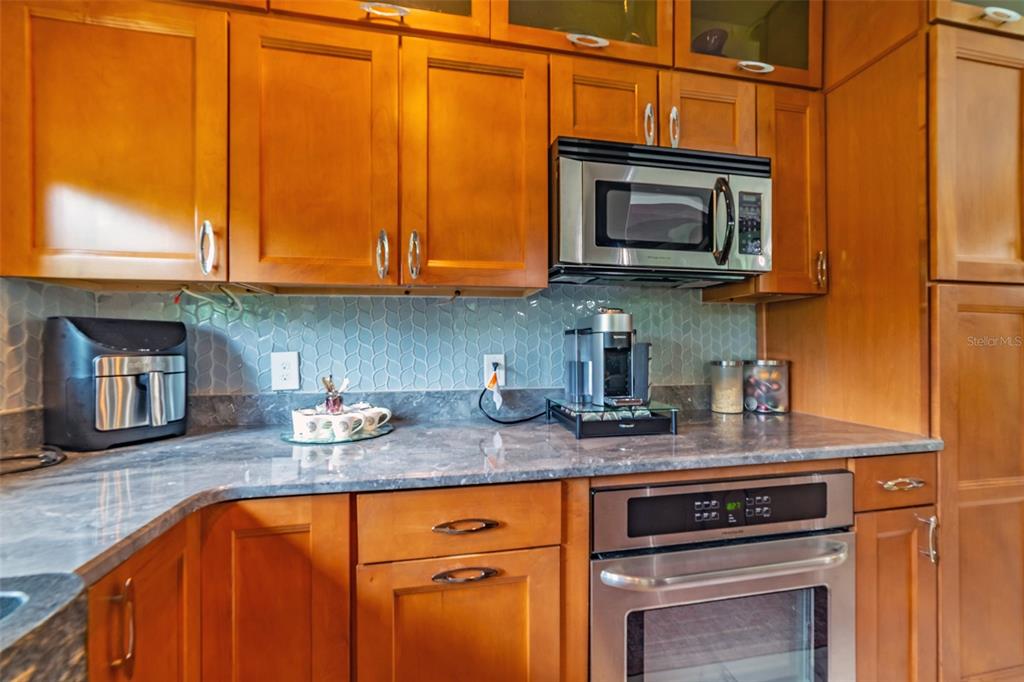 4201 West Dale Avenue Tampa, FL 33609 - Photo 21 of 77 a kitchen with stainless steel appliances granite countertop a sink stove and microwave