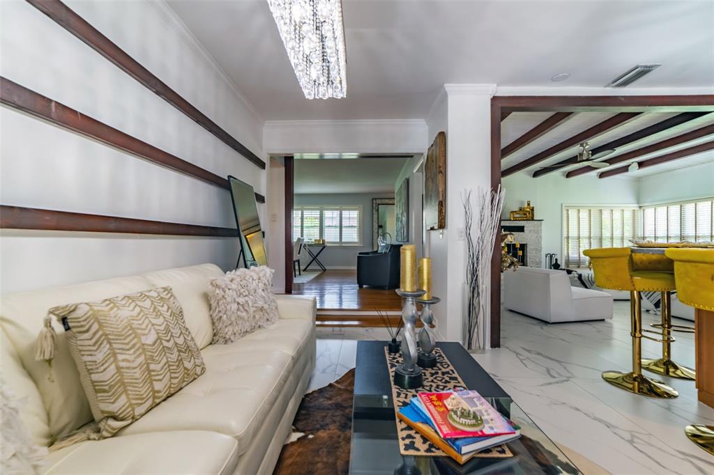 4201 West Dale Avenue Tampa, FL 33609 - Photo 26 of 77 a living room with furniture and a chandelier