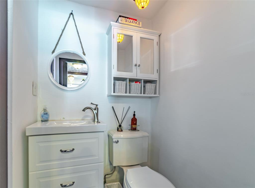4201 West Dale Avenue Tampa, FL 33609 - Photo 29 of 77 a bathroom with a toilet a sink and a mirror