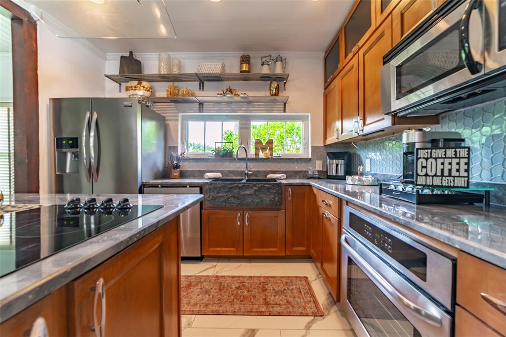 4201 West Dale Avenue Tampa, FL 33609 - Photo 3 of 77 a kitchen with stainless steel appliances granite countertop a stove a sink and a microwave