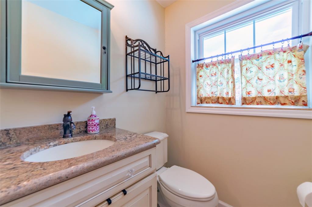 4201 West Dale Avenue Tampa, FL 33609 - Photo 39 of 77 a bathroom with a granite countertop sink mirror vanity and toilet