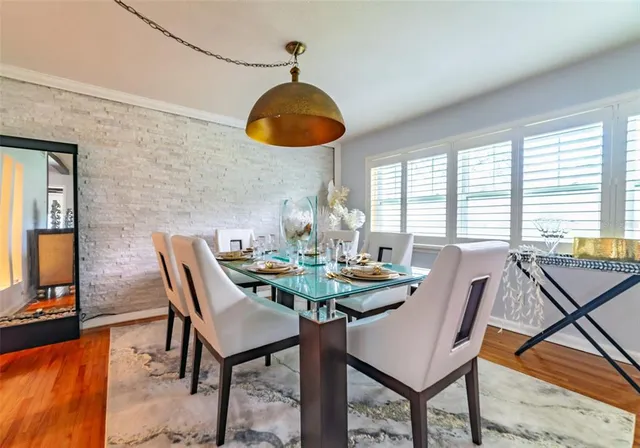 a view of a dining room with furniture and chandelier