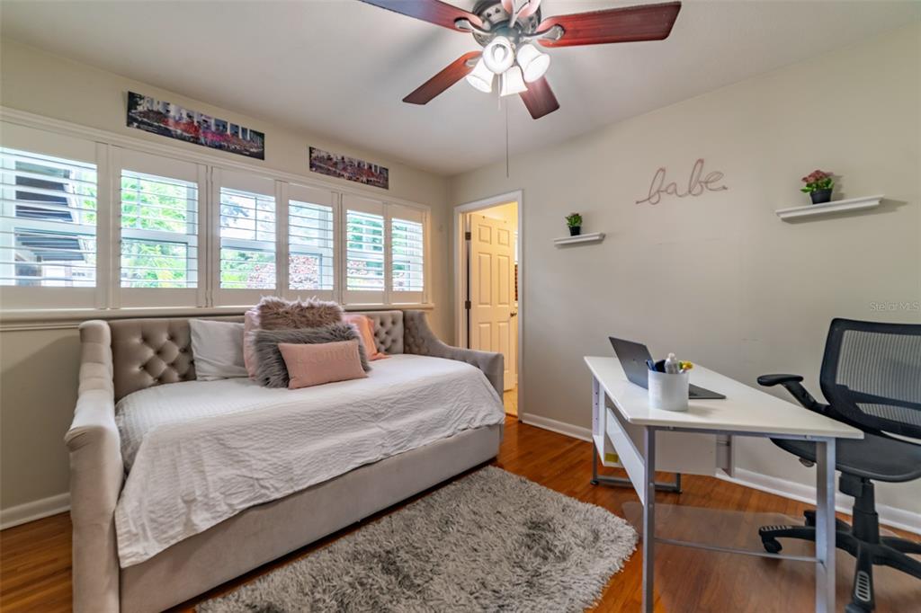 4201 West Dale Avenue Tampa, FL 33609 - Photo 43 of 77 a bedroom with a bed and a chandelier