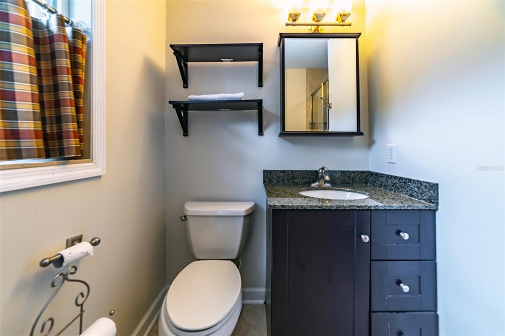 4201 West Dale Avenue Tampa, FL 33609 - Photo 47 of 77 a bathroom with a granite countertop toilet sink and mirror