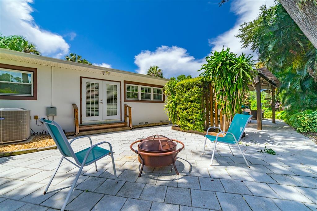 4201 West Dale Avenue Tampa, FL 33609 - Photo 54 of 77 a view of a patio with table and chairs potted plants with wooden fence