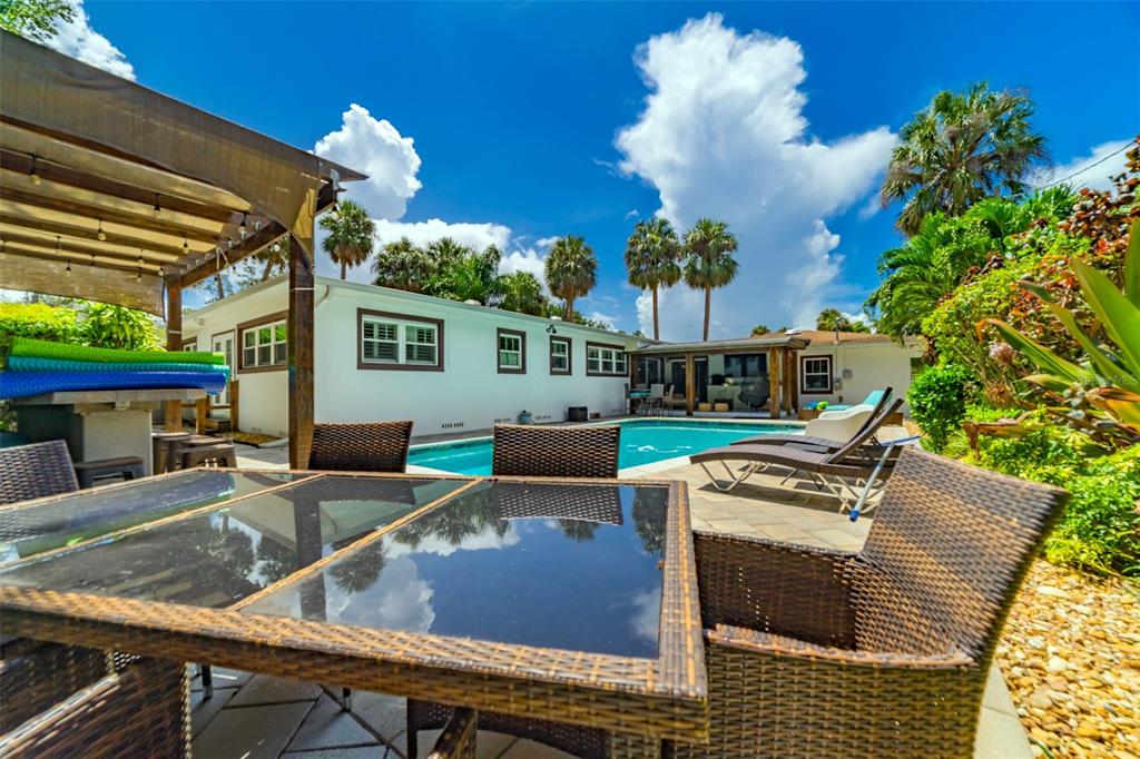 4201 West Dale Avenue Tampa, FL 33609 - Photo 56 of 77 a view of a patio with couches chairs and a potted plant