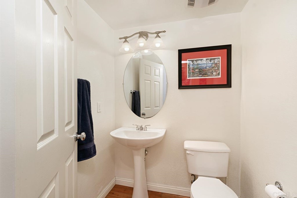 1445 Ranch Road Encinitas, CA 92024 - Photo 12 of 22 a bathroom with a toilet sink and mirror