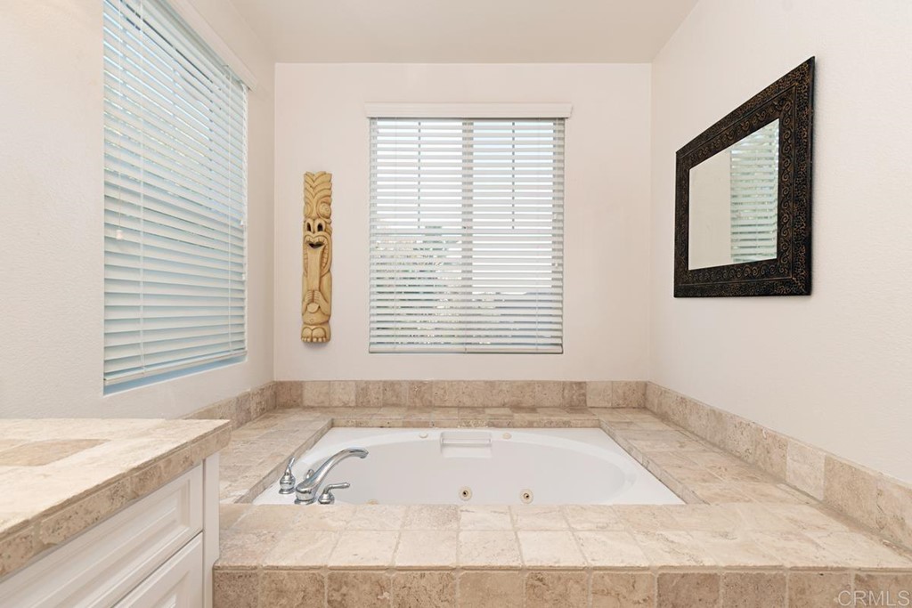 1445 Ranch Road Encinitas, CA 92024 - Photo 18 of 22 a bathroom with a bathtub and a window