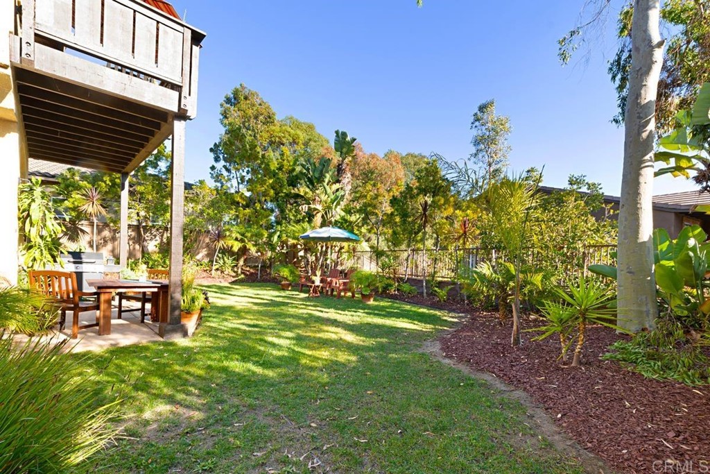 1445 Ranch Road Encinitas, CA 92024 - Photo 21 of 22 a backyard of a house with table and chairs