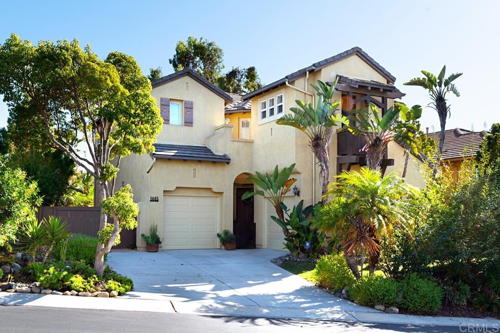 1445 Ranch Road Encinitas, CA 92024 - Photo 4 of 22 a front view of a house with a yard and garage