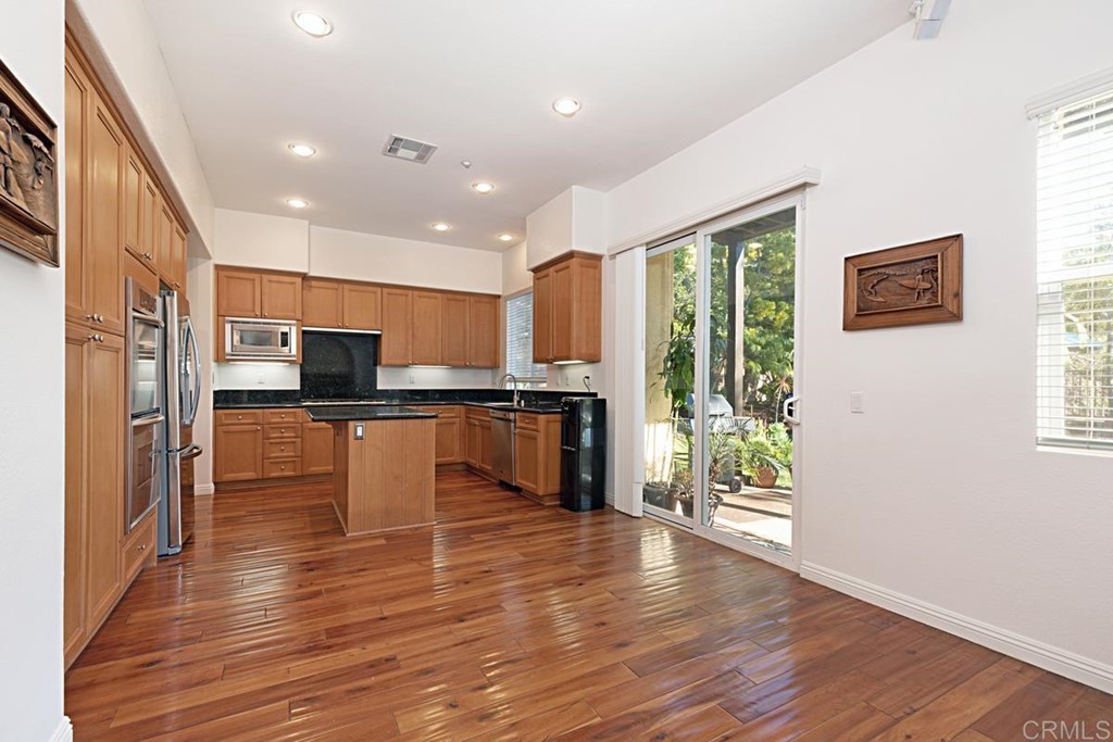 1445 Ranch Road Encinitas, CA 92024 - Photo 10 of 22 a kitchen with stainless steel appliances granite countertop a refrigerator and a stove top oven