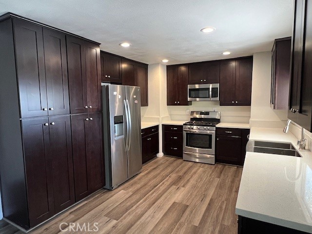 a kitchen with stainless steel appliances wooden cabinets and refrigerator