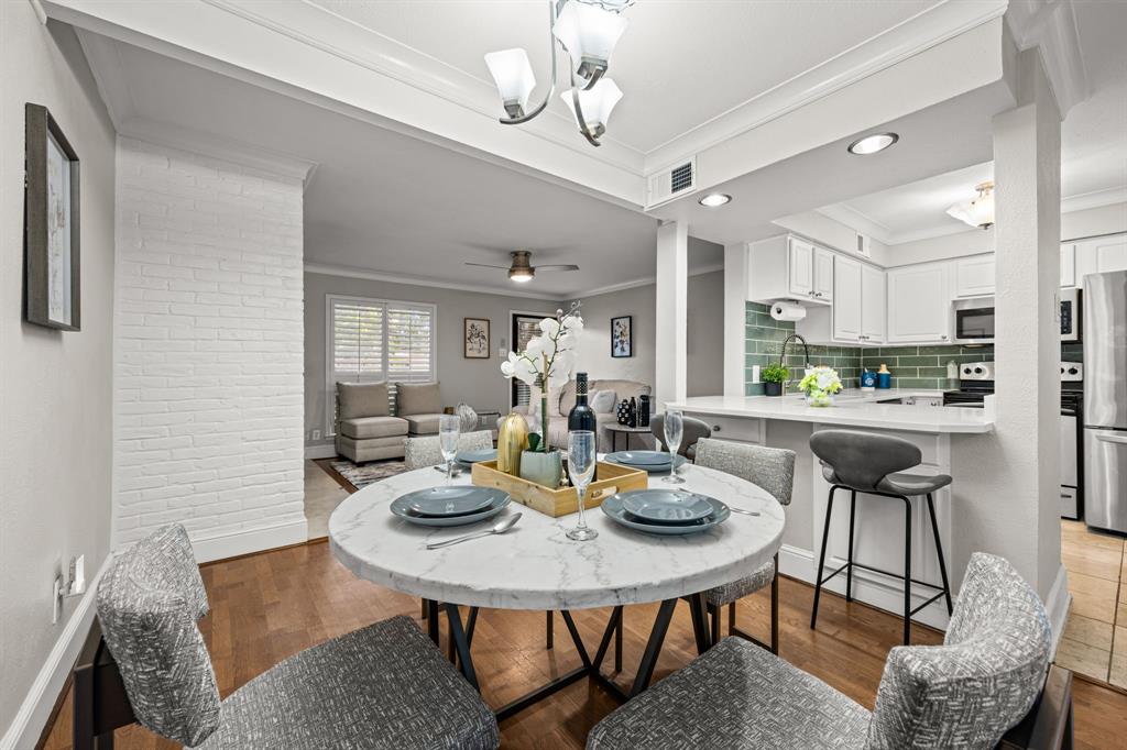 5934 Sandhurst Lane, Unit 109 Dallas, TX 75206 - Photo 5 of 14 a view of a dining room with furniture and a chandelier