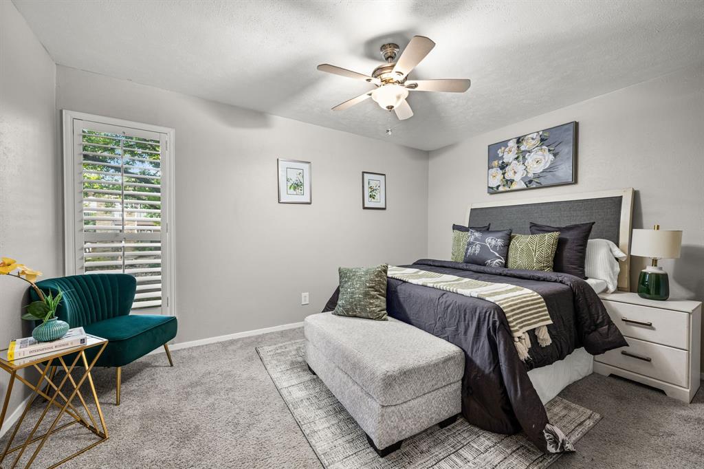 5934 Sandhurst Lane, Unit 109 Dallas, TX 75206 - Photo 6 of 14 a bedroom with a bed and window