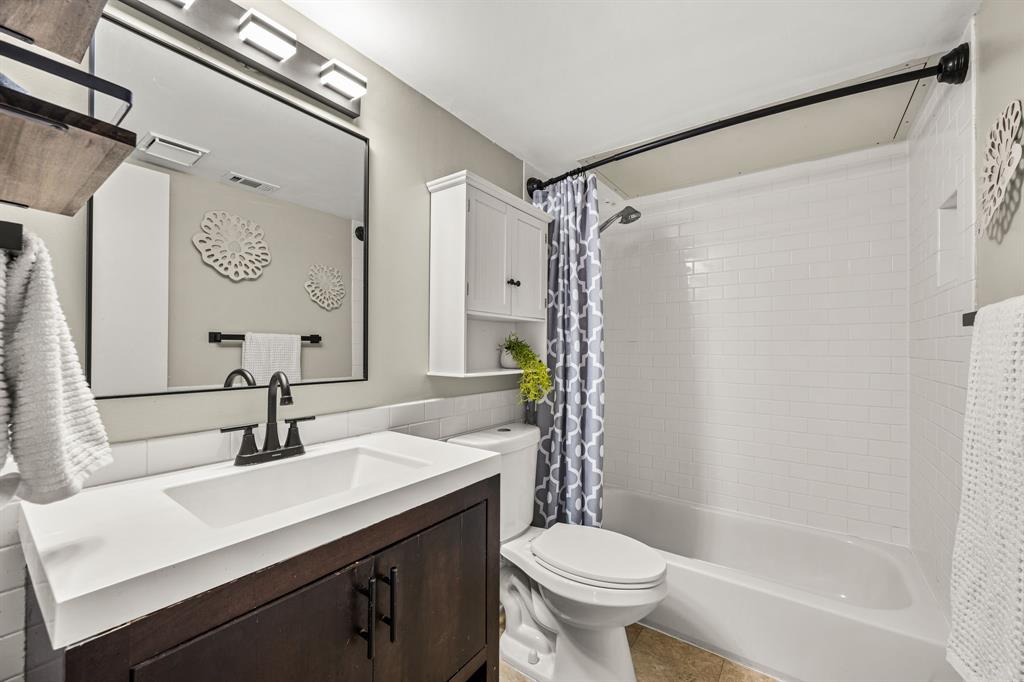 5934 Sandhurst Lane, Unit 109 Dallas, TX 75206 - Photo 7 of 14 a bathroom with a sink and a mirror