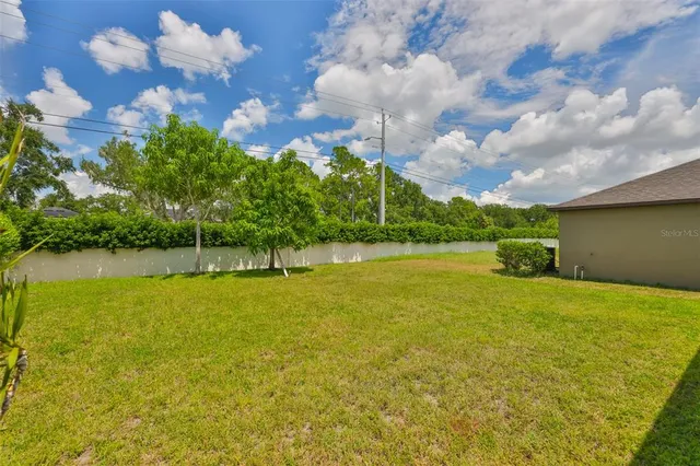 an aerial view of residential houses with outdoor space and street view