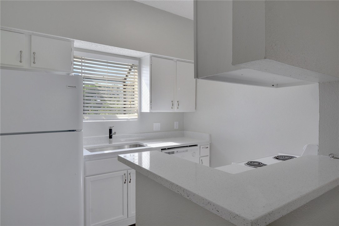 9509 Kempler Drive Austin, TX 78748 - Photo 1 of 1 a kitchen with a sink cabinets and a refrigerator