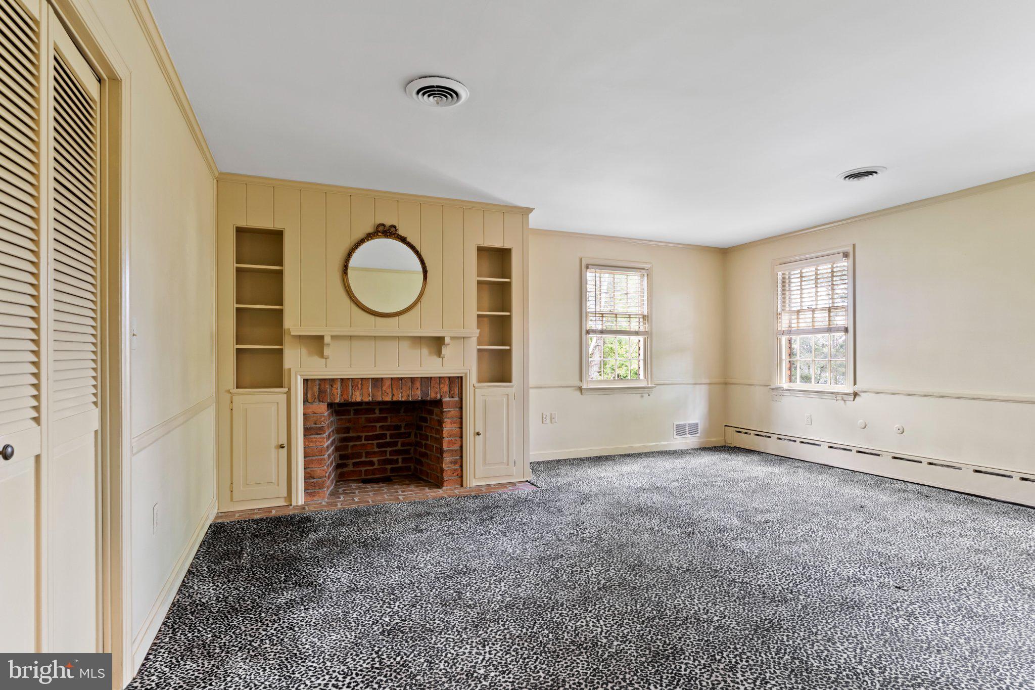 115 Kenwood Road Chambersburg, PA 17201 - Photo 44 of 74 a view of an empty room with a fireplace and a window