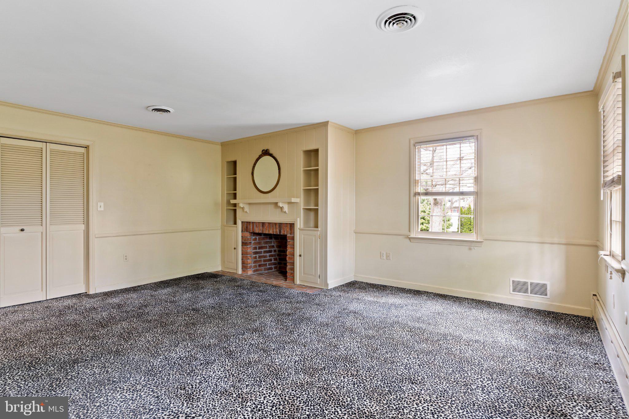 115 Kenwood Road Chambersburg, PA 17201 - Photo 45 of 74 a view of an empty room with a fireplace and a window