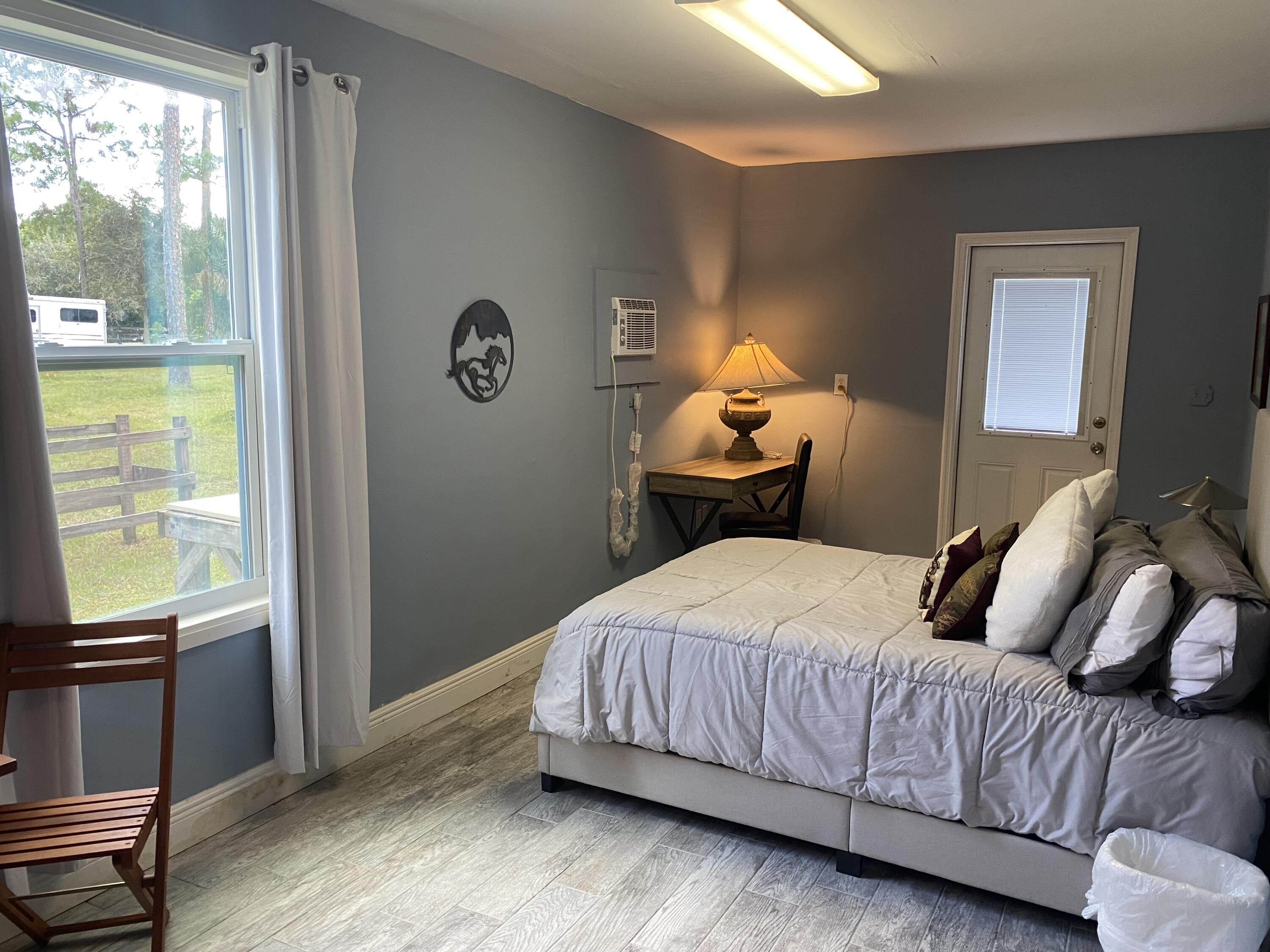 a bedroom with a bed and window