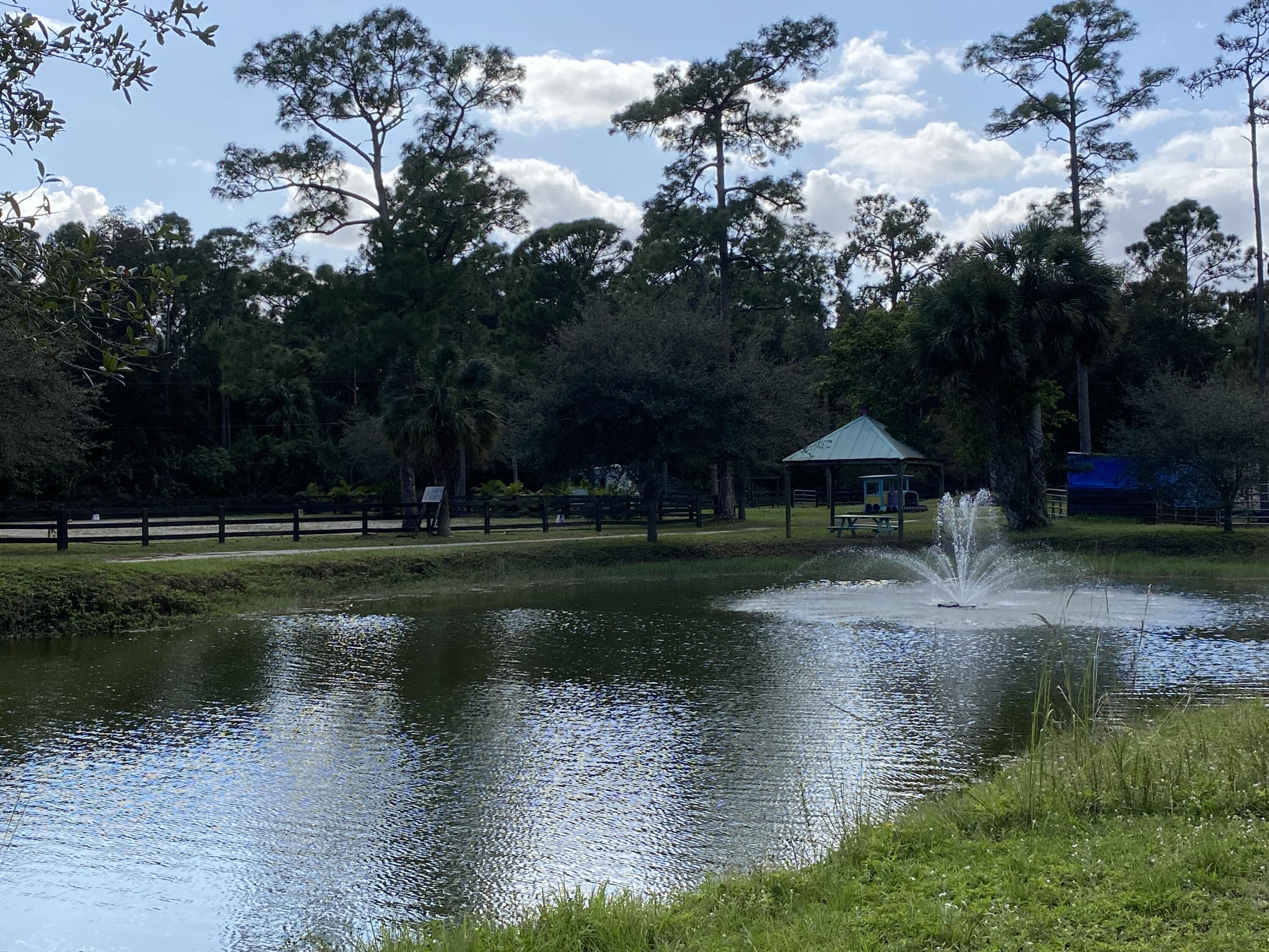 2141 B Road, Unit STUDIO 1 Loxahatchee Groves, FL 33470 - Photo 27 of 40 a view of lake with green space