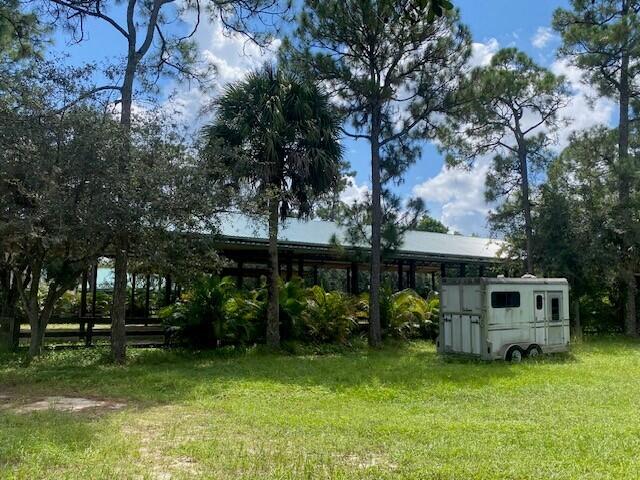 2141 B Road, Unit STUDIO 1 Loxahatchee Groves, FL 33470 - Photo 31 of 40 a front view of a house with garden