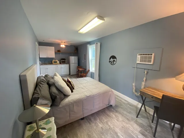 a bed room with a bed and a chair