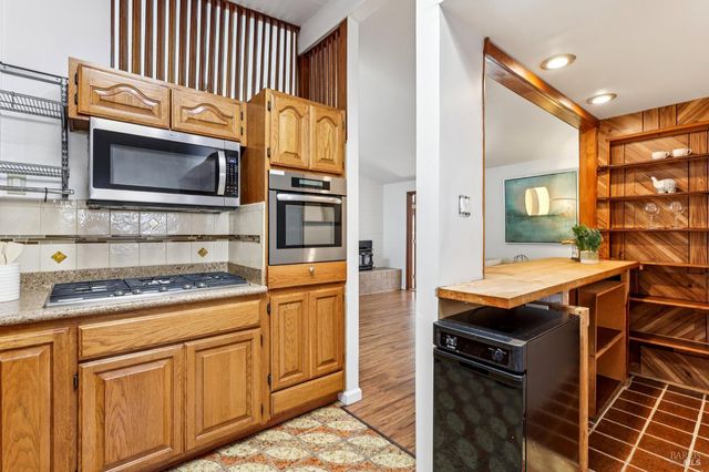 a kitchen with stainless steel appliances granite countertop a stove and a microwave