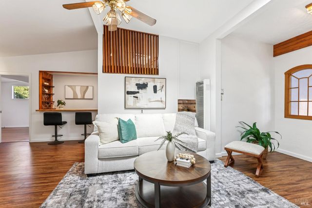 a living room with furniture a rug and a chandelier
