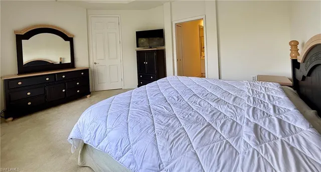 a bedroom with a bed and a dresser