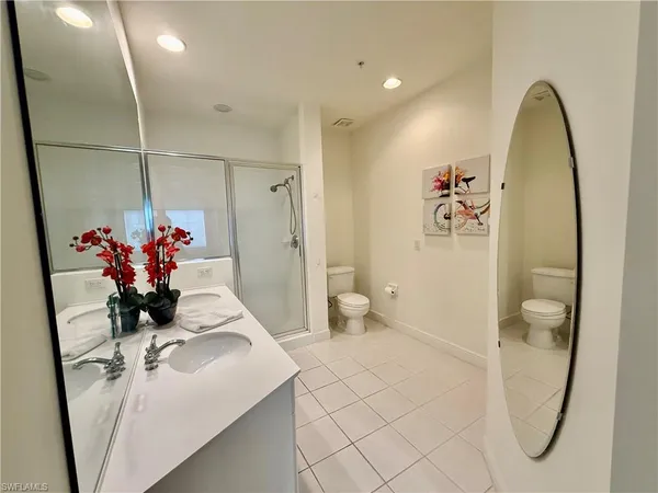 a view of bathroom with a sink mirror and shower