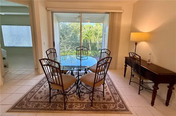 a view of a dining room with furniture and a window