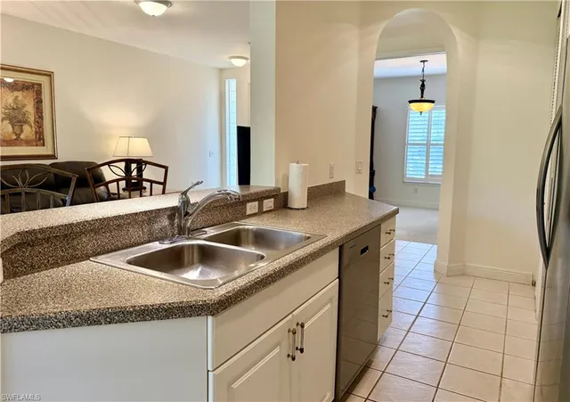 a kitchen with a sink and a refrigerator