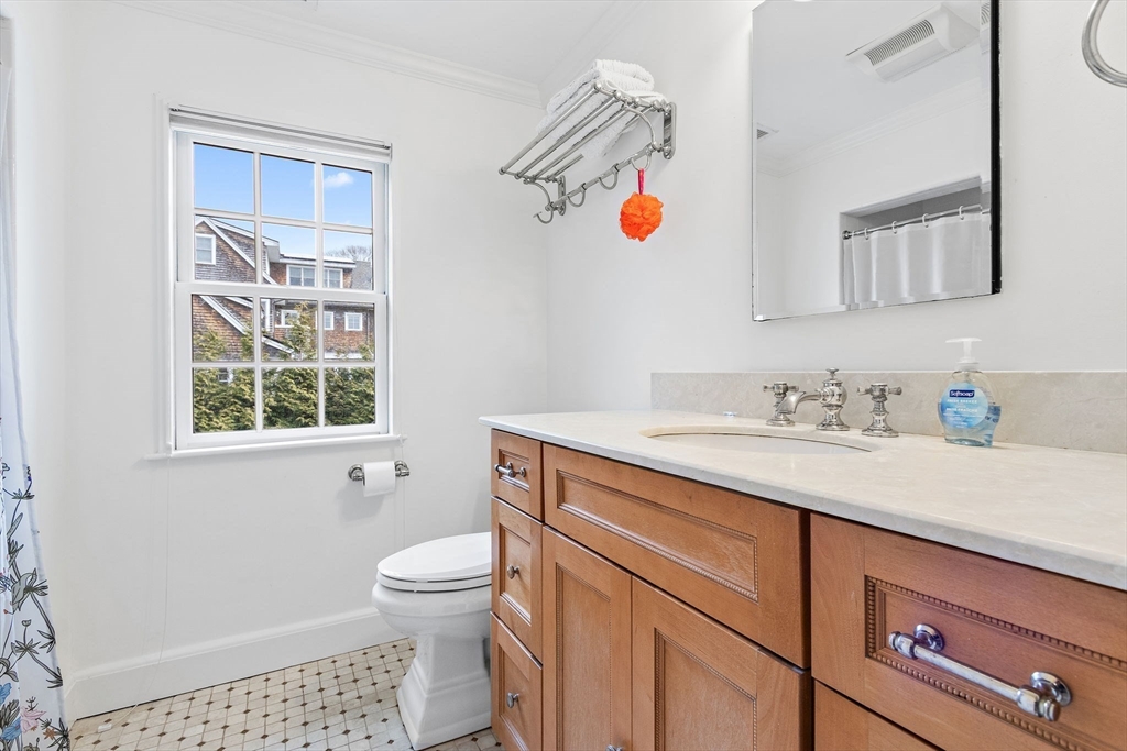 32 Pickwick Road Newton, MA 02465 - Photo 28 of 42 a bathroom with a sink a toilet and a window