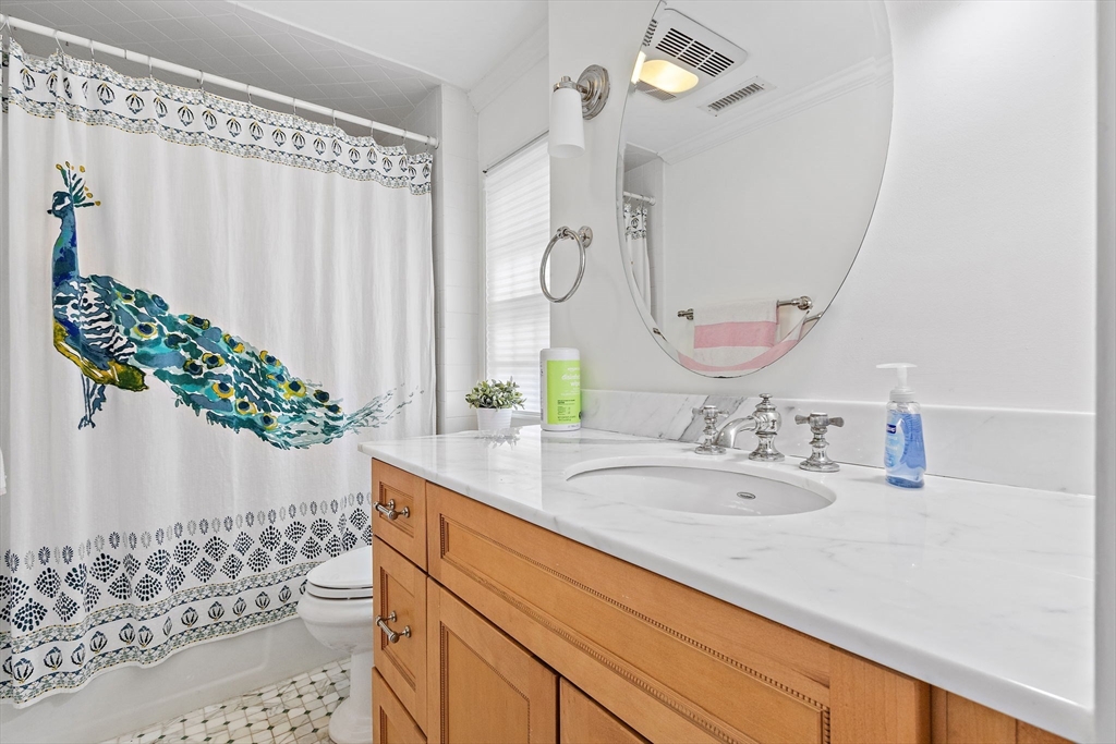 32 Pickwick Road Newton, MA 02465 - Photo 31 of 42 a bathroom with a granite countertop sink a toilet and a mirror
