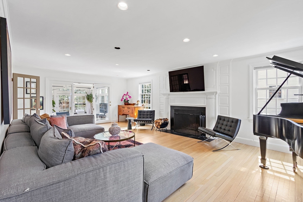 32 Pickwick Road Newton, MA 02465 - Photo 8 of 42 a living room with furniture a fireplace and a flat screen tv