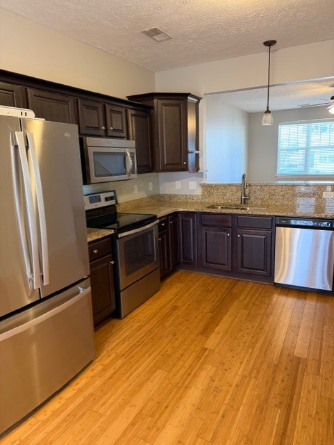 1110 Ransom Way Nashville, TN 37217 - Photo 6 of 26 a large kitchen with granite countertop stainless steel appliances and wooden cabinets