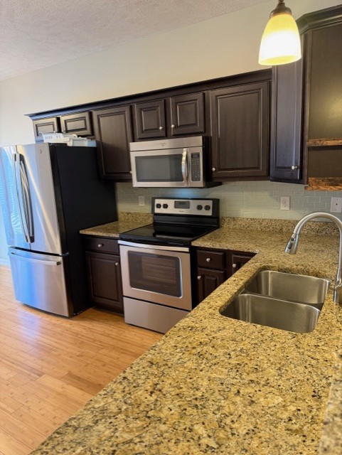 1110 Ransom Way Nashville, TN 37217 - Photo 8 of 26 a kitchen with granite countertop a refrigerator and a sink