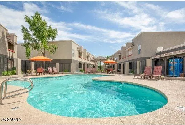 a view of a house with swimming pool and sitting area
