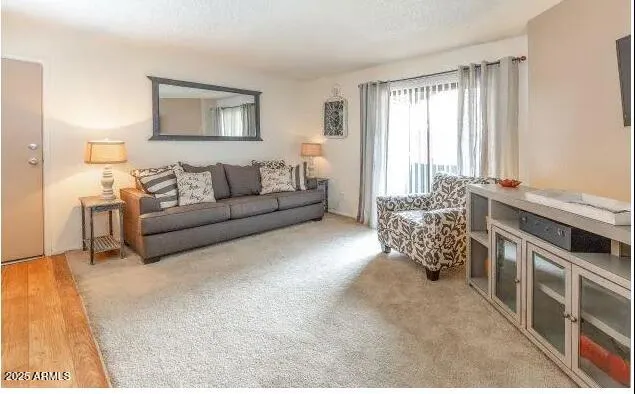 a living room with furniture and a large window