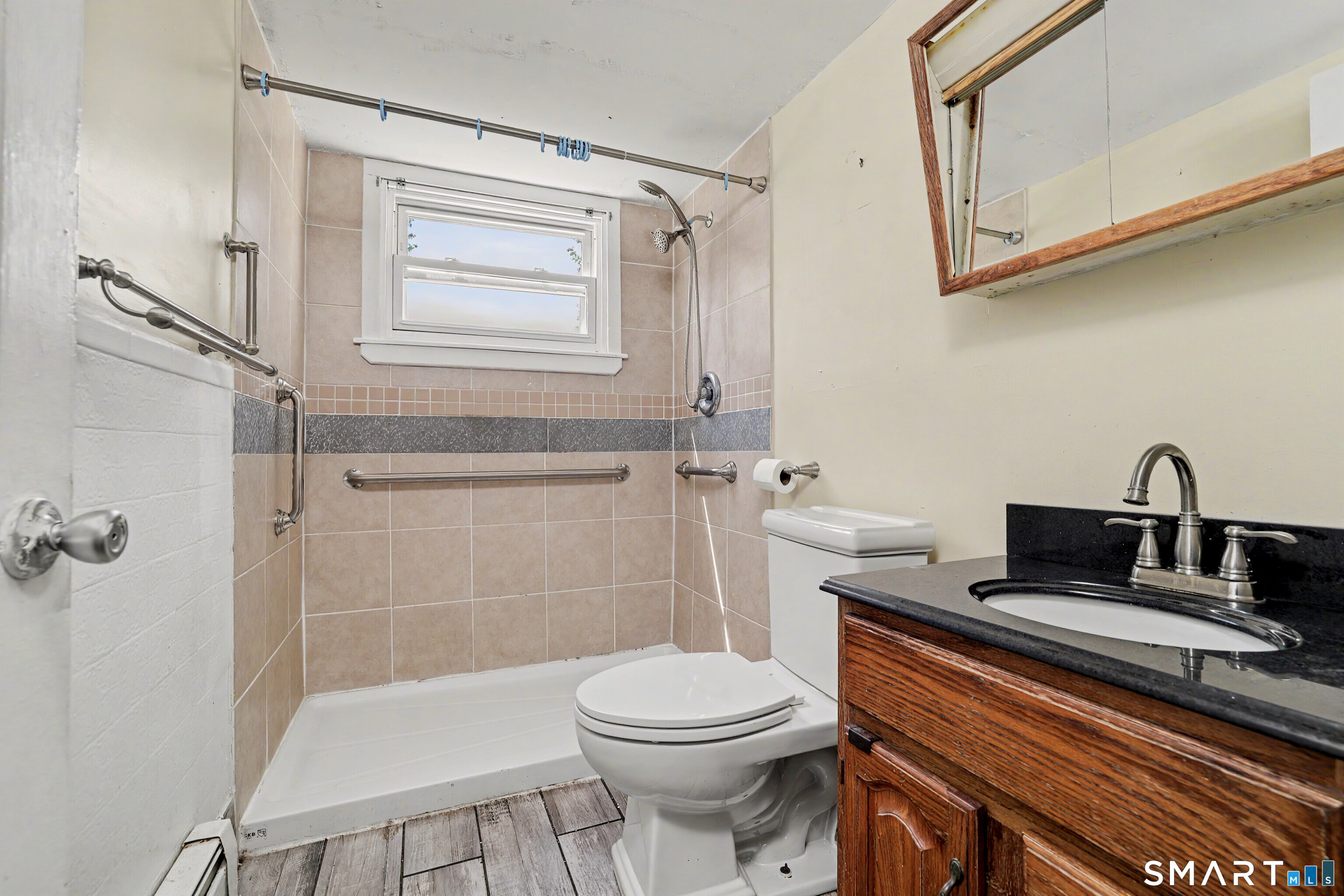 97 Boothbay Street Bloomfield, CT 06002 - Photo 23 of 33 a bathroom with a sink a toilet and shower